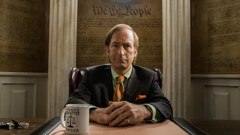 Saul Goodman sitting at office desk
